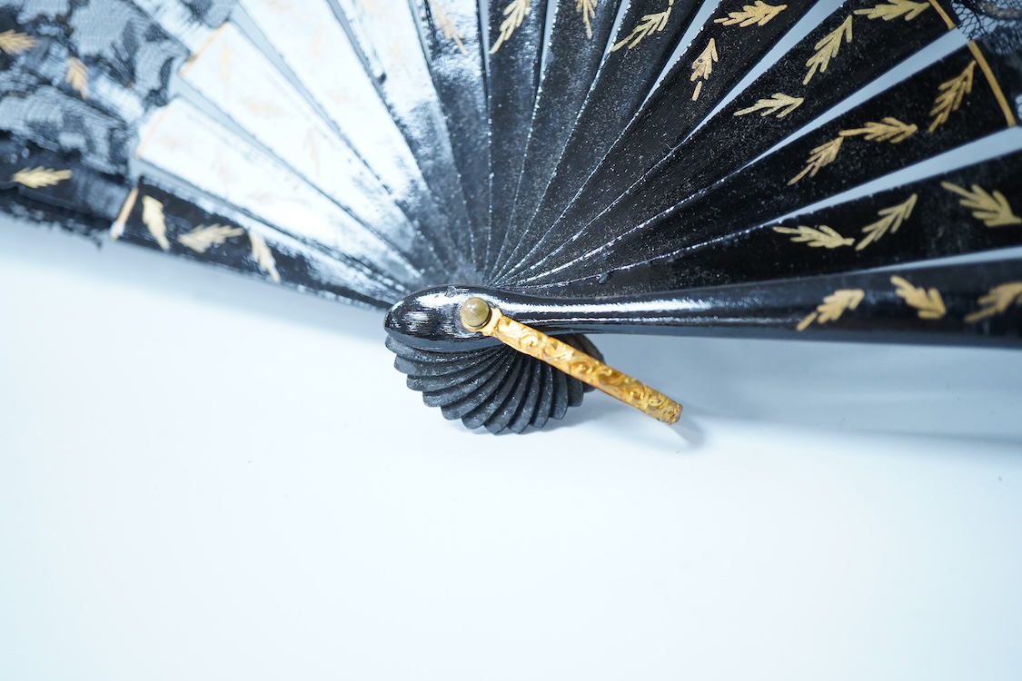 A collection of 19th century and later fans to include a black lacquered and lace example and a hand painted floral example